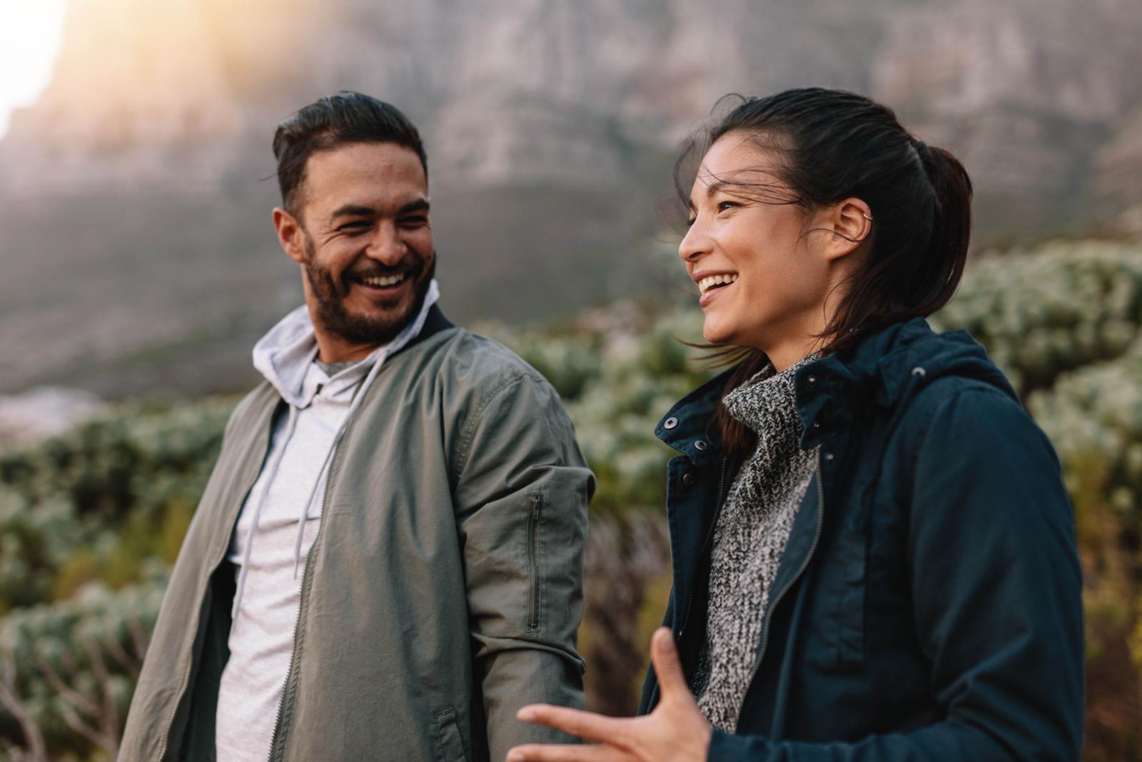Two people walking through nature