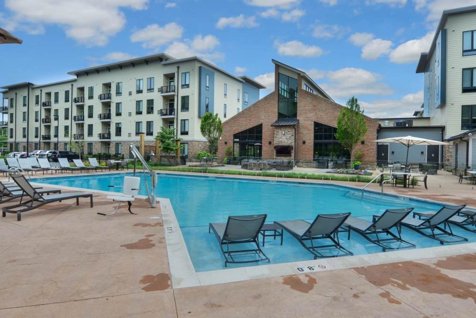 Expansive pool area with ample seating and beautifully maintained surroundings at Riverworks.