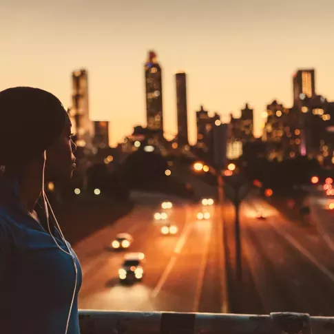 A person enjoying the stunning cityscape at dusk, highlighting the vibrant energy of the neighborhood. This image showcases the perfect balance of a peaceful environment with the convenience of city living, offering residents easy access to all the excitement the city has to offer.