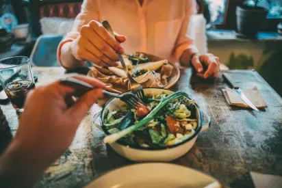 Two people sharing a salad