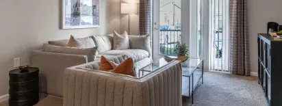 A cozy and inviting living room with access to a private balcony.