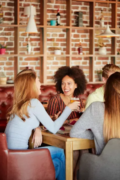 A group of friends sitting at a restaurant