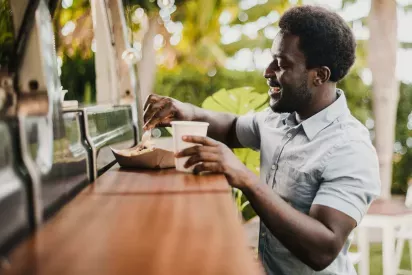 Man enjoys a meal at a food truck