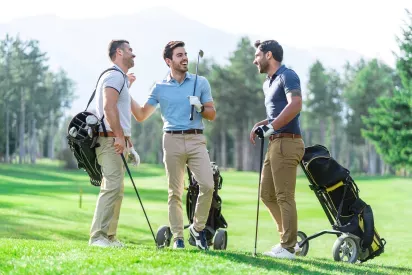 People laughing a talking at a golf course