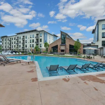Expansive pool area with ample seating and beautifully maintained surroundings at Riverworks.