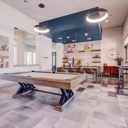 Chic clubhouse featuring a modern pool table, stylish seating, and a spacious entertainment area at The Emerson at Forney Luxury Apartments.