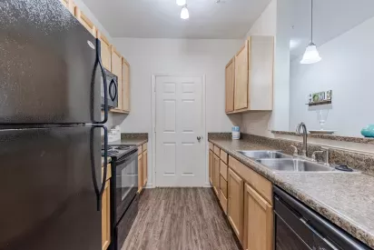 Kitchen area with ample amount of lighting and cabinet space.