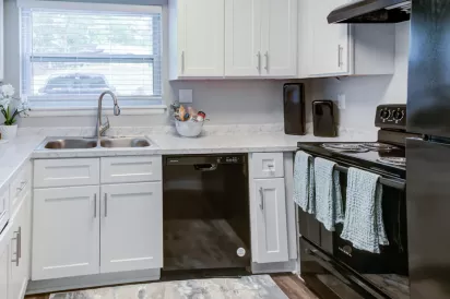 Updated kitchen with sleek appliances, and ample cabinet space.