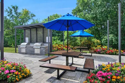 Outdoor lounge at The Royal Belmont featuring modern luxury grill area seating.