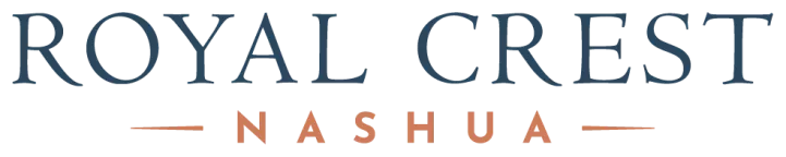 Logo for Royal Crest Nashua. 'ROYAL CREST' in large blue text, 'NASHUA' in smaller orange text with dashes.