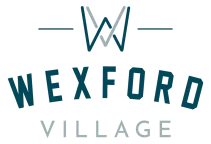 "Wexford Village" logo with a stylized 'W' symbol above, in teal and gray text.