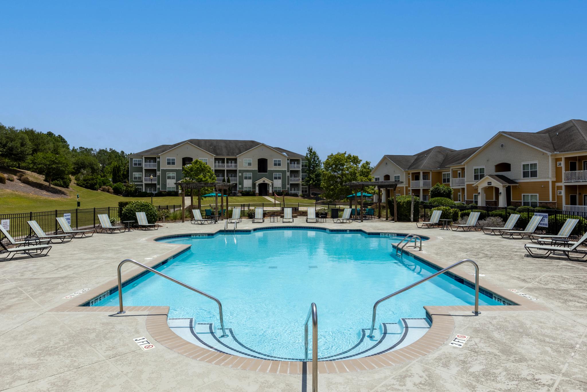 Market Street Station large, sparkling swimming pool with lounge chairs surrounding the pool.