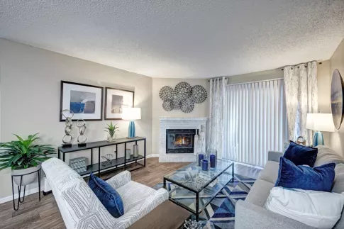 Open living room with desirable fireplace and ample seating for residents in Aurora, Colorado.