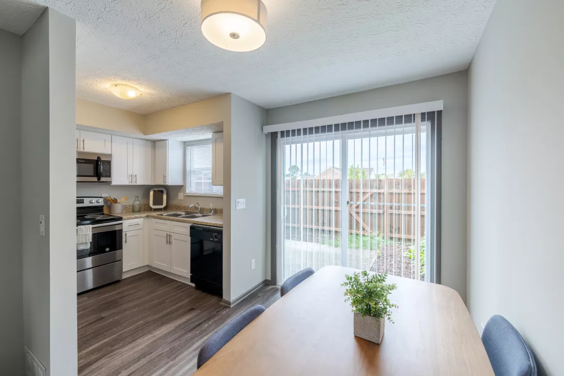 Dining room with kitchen and abundant natural lighting from window