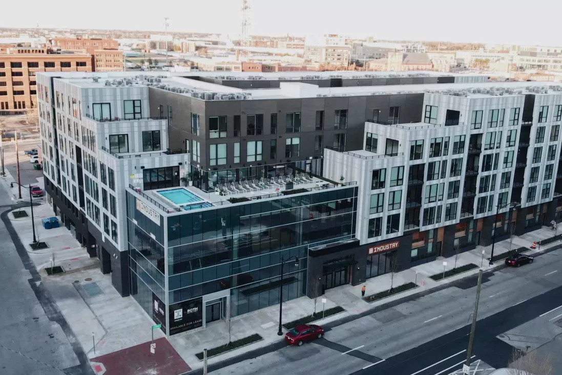 An aerial view of Industry Columbus Apartments, showcasing the contemporary exterior, rooftop pool, and surrounding cityscape in downtown Columbus.