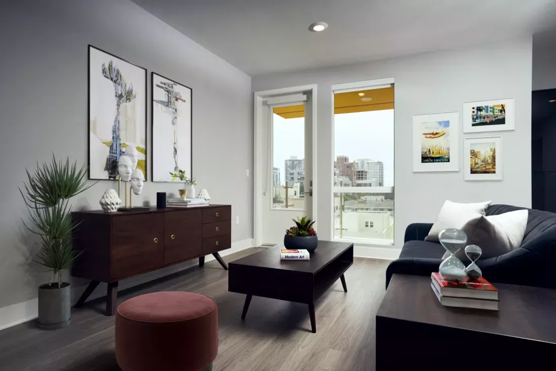 Modern living room with city views, mid-century furnishings, and decorative wall art.
