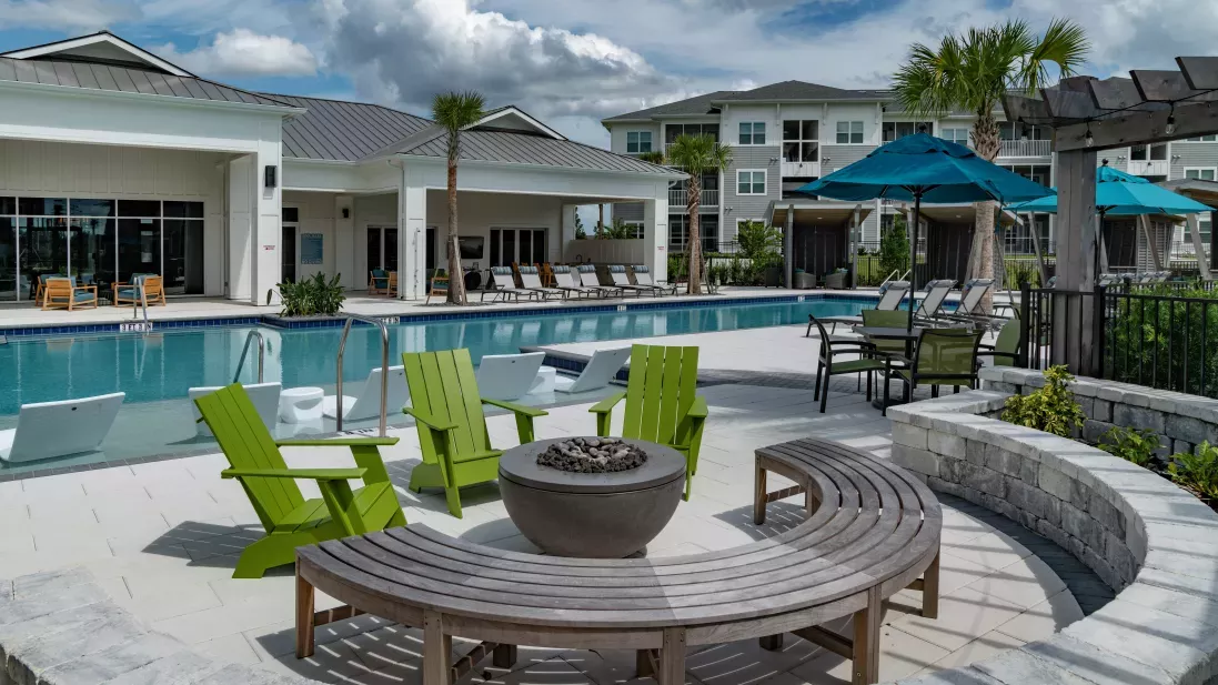 Ample outdoor seating next to a resort style sparkling pool and inviting fireplace. 