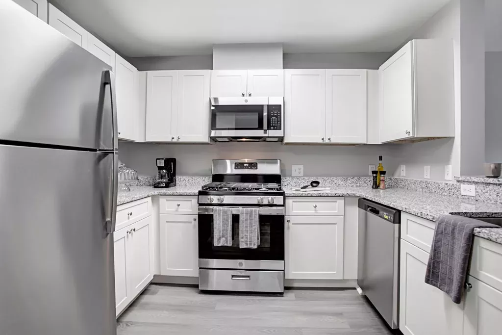 Bright, airy kitchen with stainless steel appliances and updated fixtures.