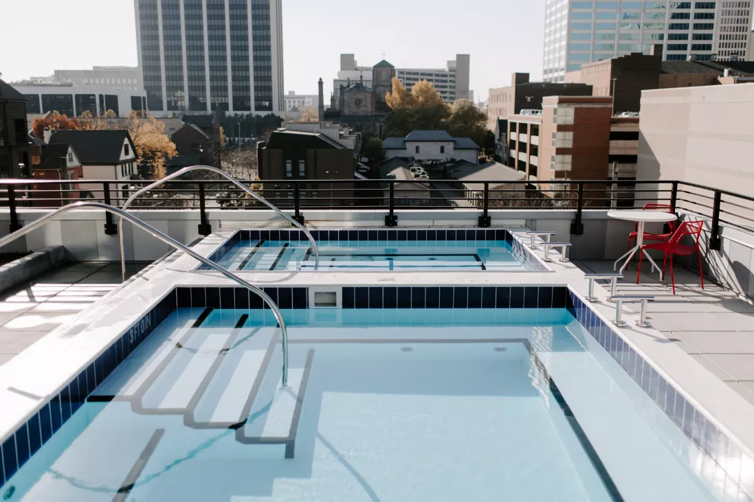 Sparkling, resort style swimming pool located on the rooftop of Industry Columbus with incredible skyline views.