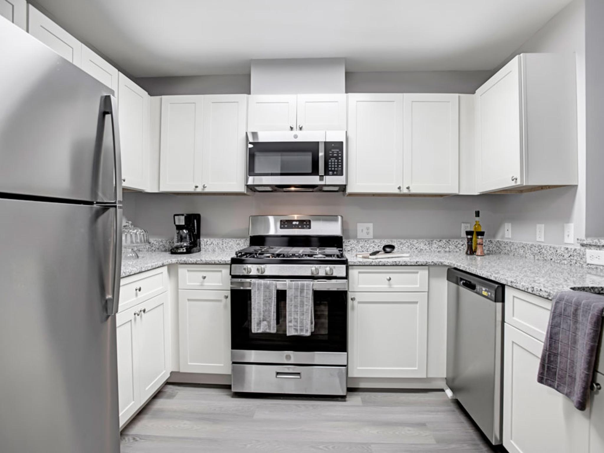 Bright, airy kitchen with stainless steel appliances and updated fixtures.