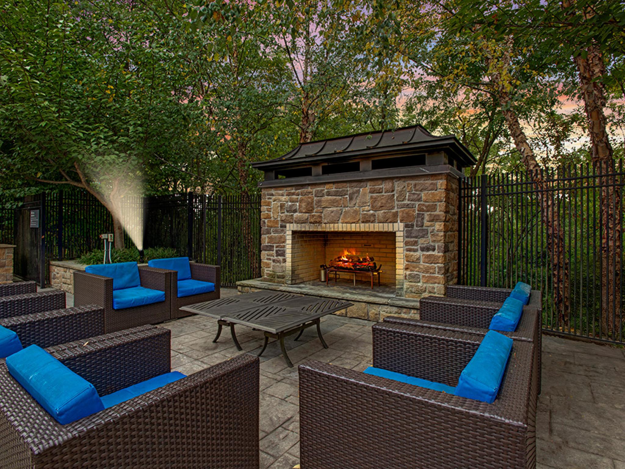 Outdoor fireplace with ample seating to enjoy late nights outside.