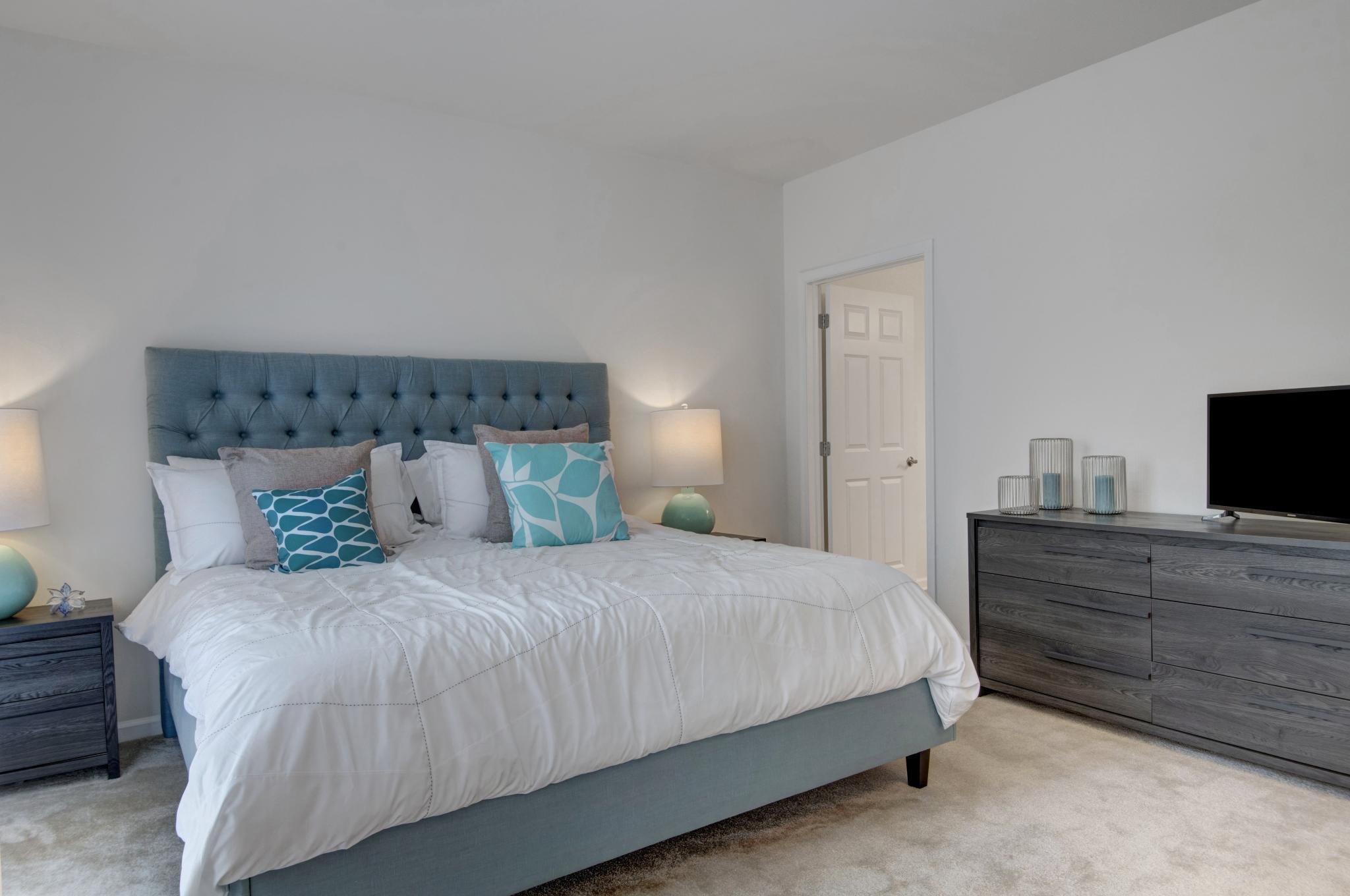 Large, bright bedroom with adjacent bathroom for potential renters. 